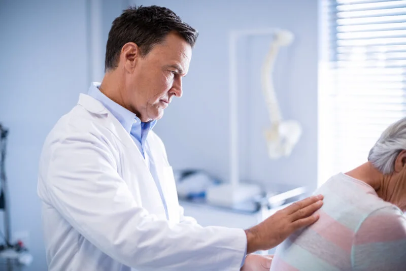A physical medicine specialist treats a patient in a doctor’s office in North Texas