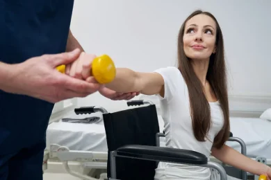 A physical medicine doctor assists a patient in a doctor’s office in North Texas